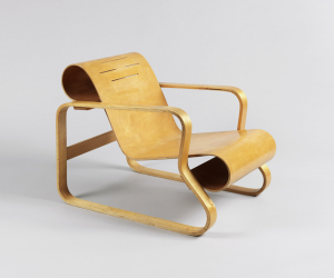 urved bent birch plywood seat joined to frame composed of ribbon-like curved, laminated bent birch elements forming legs/arms; form reinforced by solid birch cross pieces at curled ends of back and seat, and at rear legs.