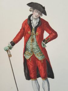 Image features man in matching red coat and breeches with blue vest.