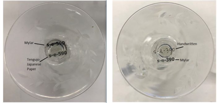 A composite image of two photographs. Both depict the underside of a wine glass, each with accession numbers handwritten and printed and adhered to the glass.