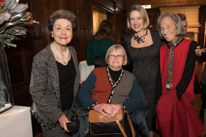 Nancy Marks, Dianne Pilgrim, Caroline Baumann, and Barbara Mandel smiling in the Great Hall.
