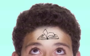 a young boy with a drawing of a book over his forehead
