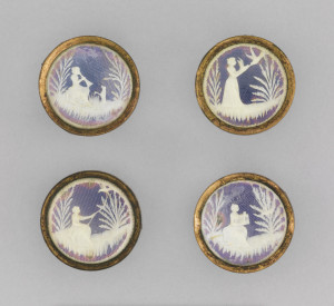 Four buttons depicting a young woman catching a bird, from bird call to bird cage, all in carved ivory over a colored foil ground.