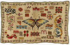 Scattered motifs, mostly geometric, dominated by large butterfly in the center, embroidered in many colors on a natural linen ground. With a flowering vine border.