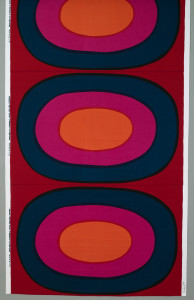 Length of printed cotton with a very large-scale design of concentric ovals in orange, fuchsia, black and purple on a red ground.