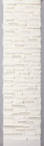 This paper is composed of small overlapping rectangles of white paper in varying sizes sewn onto a white paper backing. These squares are sewn in horizontal rows evenly spaced several inches apart.