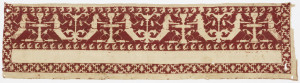 Embroidered band, white designs on red background