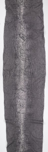 Length of metallic silver and black fabric with a variably puckered surface that resembles the skin of a crocodile.