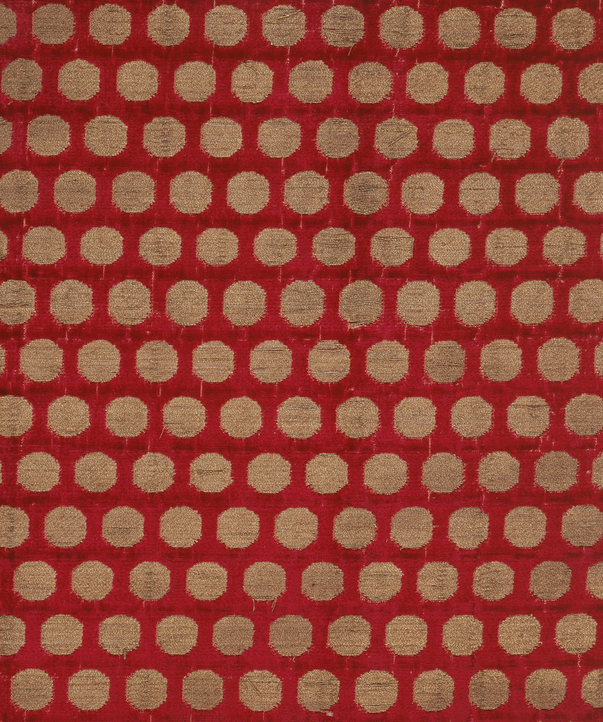 Deep red velvet with offset repeat pattern of gold disks. The foundation is plain weave formed by a red silk warp and tan silk weft.