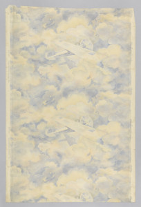 Vertical rectangle, a full width, repeating vertically, showing two and one half repeats. Airplane, the "Spirit of St. Louis", with name lettered on fuselage, against a background of cloud shapes on which the plane's shadow is cast. Printed in blue, red and light yellow. Children's paper.