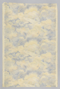 Vertical rectangle, a full width, repeating vertically, showing two and one half repeats. Airplane, the "Spirit of St. Louis", with name lettered on fuselage, against a background of cloud shapes on which the plane's shadow is cast. Printed in blue, red and light yellow. Children's paper.