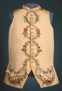 Gentleman's waistcoat in ivory silk faille with embroidery on collar, pockets, center fronts and lower edge. Embroidered in 22 shades of silk with floral garlands which form circles down the center front when the waistcoat is buttoned.