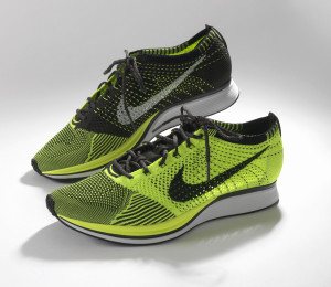 Oblique view of a pair of HTM Flyknit running shoes on white background