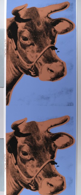 In photographic half-tone enlargement, the head of cow in twice-life-size dimensions. Design is repeated vertically. Printed in coral and black on deep blue background.