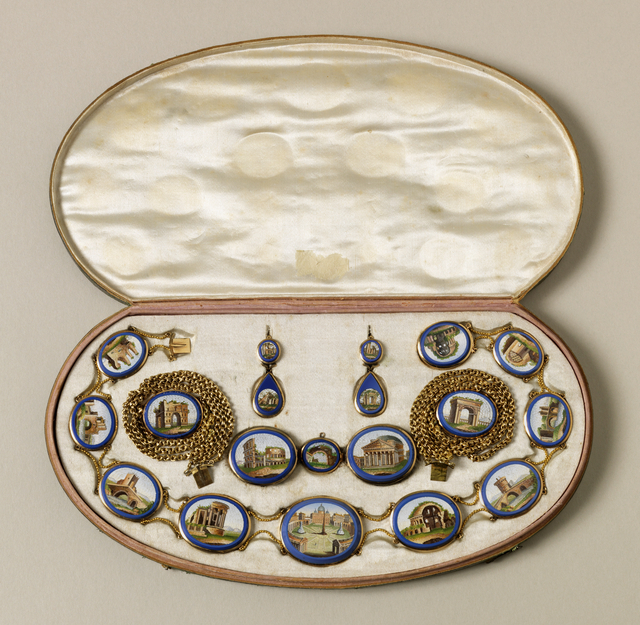 Suite of jewelry with gold filigree mounts around micromosaic oval scenes of Rome in cobalt blue borders; comprising a necklace centered by a view of St Peter's, with various ruins, and the Colisseum, and Pantheon; a pair of gold bracelets each with one arch view, a pair of earrings, and a pair of brooches.