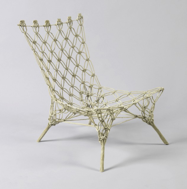 Rigid, epoxy-impregnated, light green one-piece form composed of aramid fiber rope criss-crossed and knotted into the shape of a low four-legged chair.