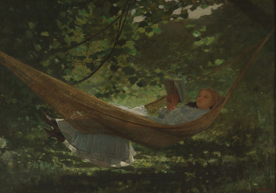 Horizontal view of a young woman in a white dress, lying in a hammock with her feet over the edge, reading a book. She is in a setting of sunlight-dappled trees and grass.
