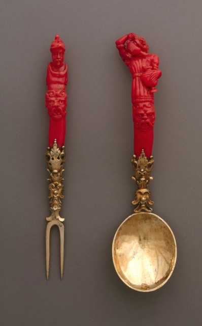 gold fork and spoon with red handle