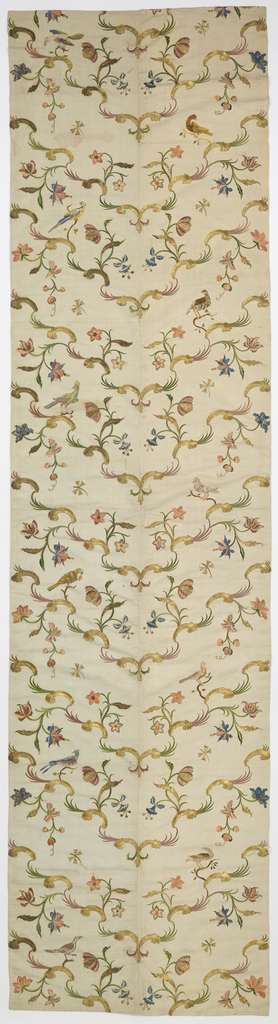 Bed hangings of heavy white silk, embroidered in gold thread, gold foil strips, and colored silks. Each panel is made up of two breadths of fabric seamed down the center and is lined in white silk plain weave. The design is arranged so that golden rococo curves meet at the center seam to form a symmetrical v-shaped pattern, with flowering branches and birds, worked in satin stitch in colored silks. While the flowers are symmetrical, the birds are vertically off-set; each panel shows eleven birds, all different, which appear to be taken from a set of ornithological prints by Xaviero Manetti. Metallic effects in several textures are created with couched crimped gold lamella and couched foil-wrapped silk-core threads.