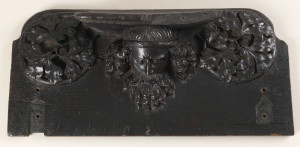 Two roughly rectangular choir seats, each carved on undersurface, with shallow rests supported by: a stooped figure of a bearded man flanked by foliate roundels (-1a); head of a bearded man with flowing hair, flanked by foliate roundles (-1b); each seat with indentations for hinges on lower left and right.