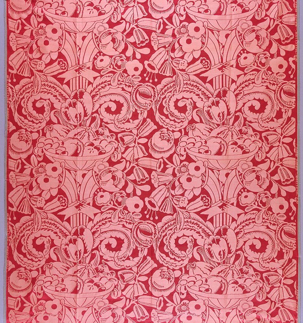 red textile with brocade pattern