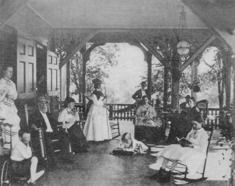 lots of people gathered around on an outdoor porch