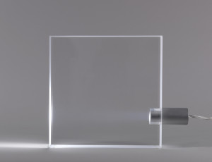 Body composed of thick, transparent methacrylate square with removeable aluminum bulb housing inserted in lower section of one side.