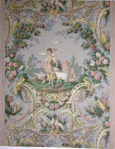 A large medallion of pastoral scene. In foreground, young woman feeding pigeons, a lamb bedside her; ruined tower in distance. Enclosing framework of rococo scrolls and foliage. Garden tools, doves and roses. Printed in gold, green and apricot on slate-gray field.