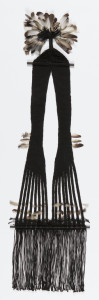 Woven hanging of black linen with wide fringe at bottom, ornamented with feathers
