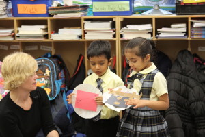 two kindergardeners present their design prototypes for the class with the help of a museum educator