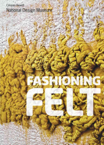 book cover showing a wall covered in squiggly, mustard-yellow, abstract felt formations