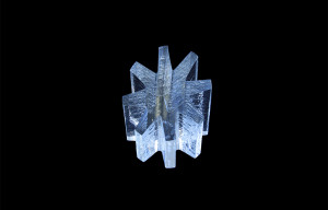 a photo of the awards trophy, a stout glass asterisk, against a black background