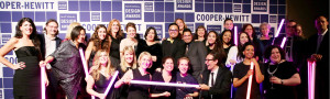 a group shot of lots of smiling people, in fancy attire in front of a step-and-repeat that says Cooper Hewitt National Design Awards all over it.