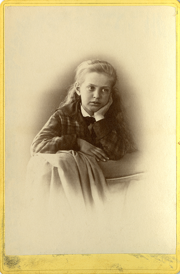 Photo of young girl with head in hands