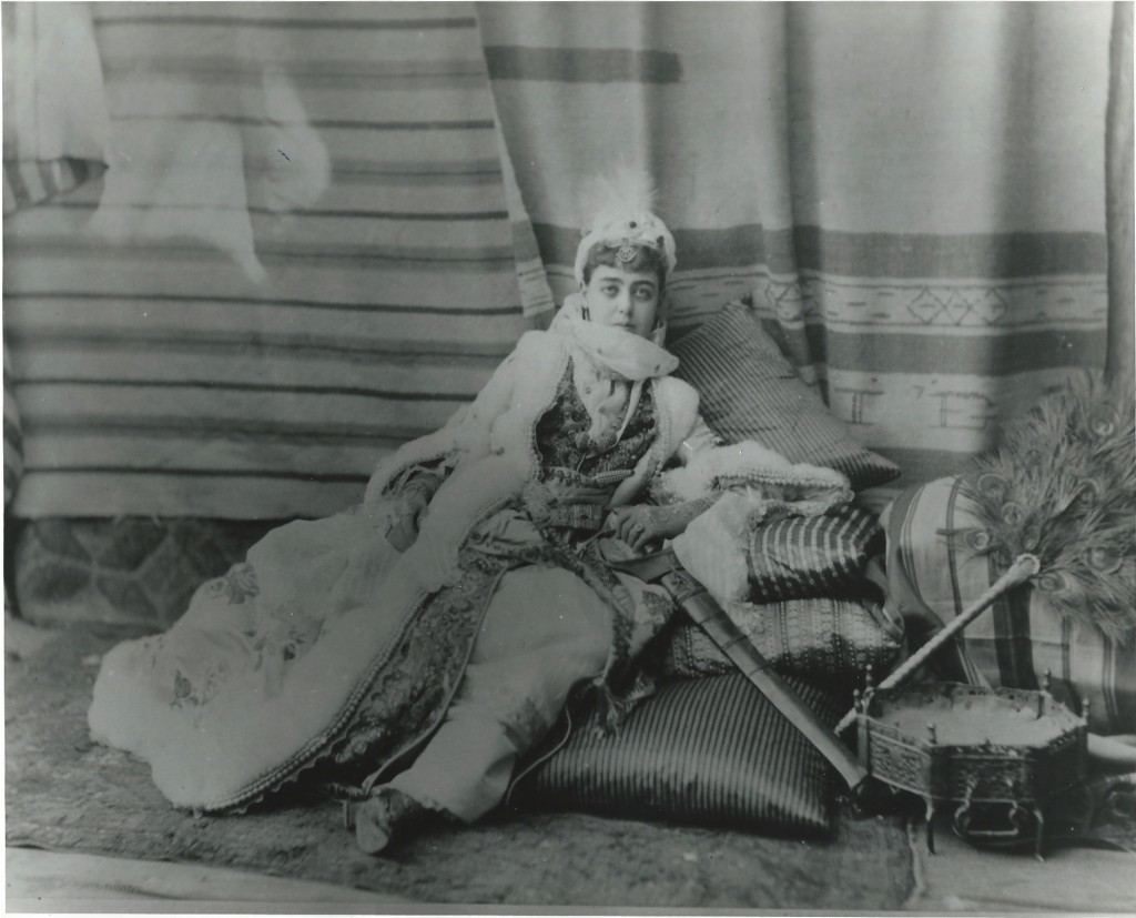 woman in lots of layered garments sprawled out on a floor pillow