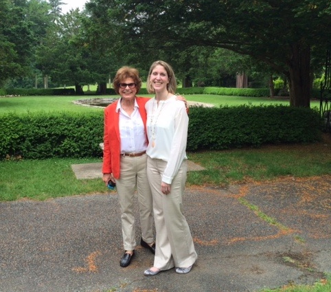 Two women smiling for the camera with arms around each other