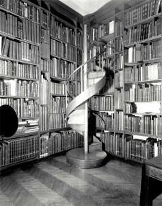 Spiral staircase in the corner of a well-stocked library