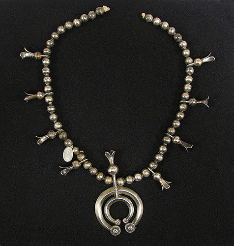 Silver necklace on black backdrop
