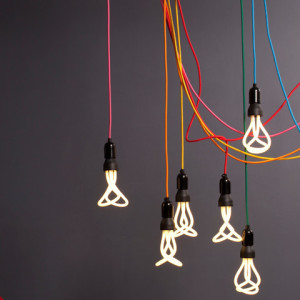Two looped and angled glass tubes projecting from a short, tapering black cylindrical housing with threaded metal end for insertion into light bulb socket.