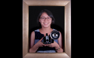 woman holds camera