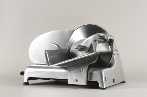 Aluminum and steel streamlined meat slicer with rounded knobs.