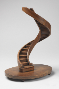 Spiral staircase model with curved stringboards, on a circular base on bun feet.