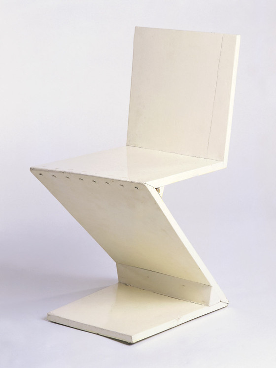 Z-form chair constructed of wide planks; rough construction painted white.