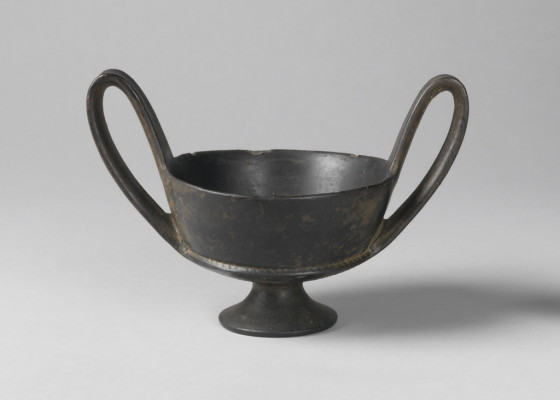 Footed cup with two high looped handles.