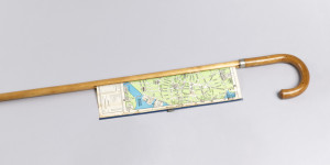 Cane with polished crook handle and short steel tip; extendable map of the city of Boston housed in shaft.