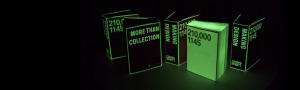 five chunky books, shaped like oversized bricks, standing upright in a dark display. the text glows green. on one book, the text is black/negative space and the background is the part that's glowing.
