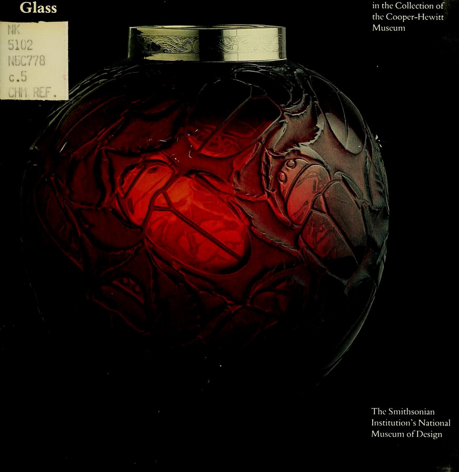 a glass orb with organic textured forms, looks a bit like a repeating pattern of scarabs but it's hard to tell, on the surface, dimly glowing red, almost like a human heart, set against a black backdrop