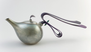 Silver-plated bulbous body tapering into elongated spout on one side; opposite spout, long handle composed of two curved, deep purple anodized aluminum elements overlapping and extending outward, joined by two green onyx beads at point of contact with each other. Circular lid with small square knop topped with curved, deep purple anodized aluminum tab handle.