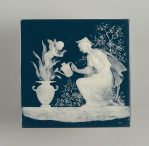Square with greenish-blue ground having white decoration consisting of a kneeling woman wearing conical hat, long robe, watering a plant in classical vase at left, from which a cherub rises.