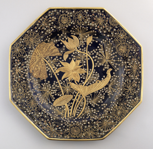 Octagonal shape with gold-banded edge. Heavily gilded, incised water plants in center, with space-filling floral and leaf forms of gold, with enamel color dots and smaller gold dots. Porcelain with blue underglaze decoration, overglaze enameling and gilding.