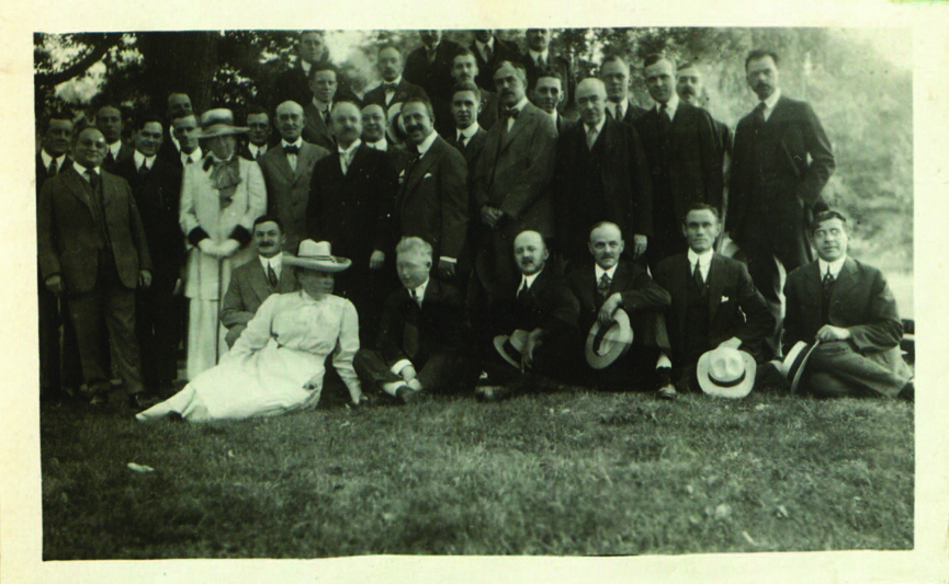 group of people sitting on a lawn